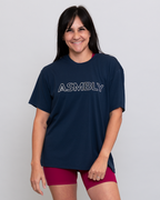 Woman wearing a navy blue 'ASMBLY' t-shirt on a light gray background